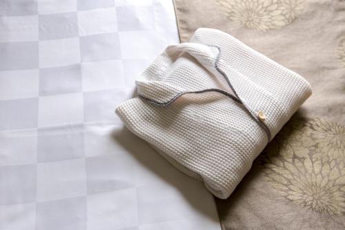 a white cloth napkin sitting on top of a bed at Takamatsu Tokyu REI Hotel in Takamatsu