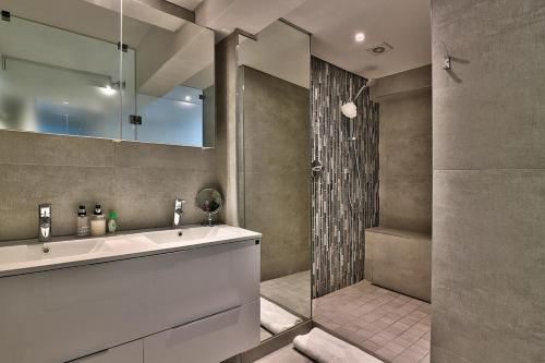 a bathroom with a sink and a shower at Clifton Studio in Cape Town