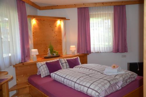 sypialnia z łóżkiem z drewnianym zagłówkiem w obiekcie Ferienwohnung Annemarie w mieście Virgen