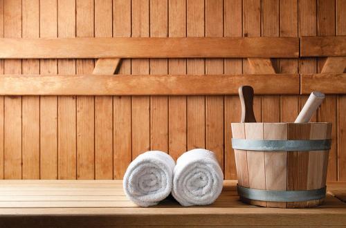 a pair of towels and a cup in a sauna at Crystal Springs Beach Hotel in Protaras