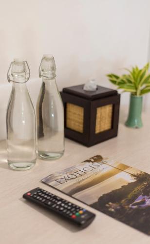 two bottles of water and a remote control on a table at Menjangan Ecolodge - CHSE Certified in Banyuwedang