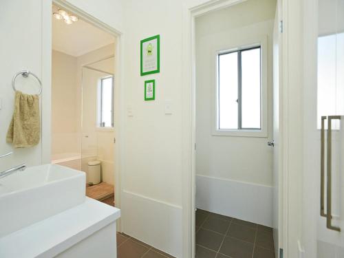 a bathroom with a white sink and a mirror at Boomer Beach Retreat - Pet-Friendly - WiFi in Port Elliot