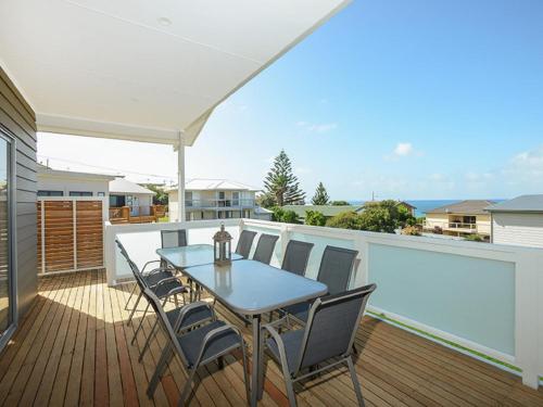 a patio with a table and chairs on a deck at Boomer Beach Retreat - Pet-Friendly - WiFi in Port Elliot