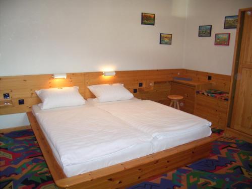 a bedroom with a large white bed in a room at Smile Hotel in Nürnberg