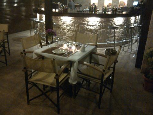 a dining table and chairs in a room with a table and chairsktop at Kallicrates Village in Frangokastello