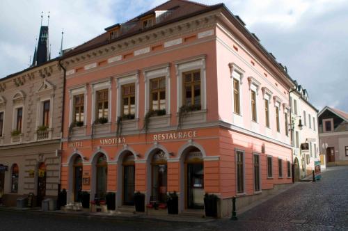 a pink building on the side of a street at Hotel Merlot in Louny