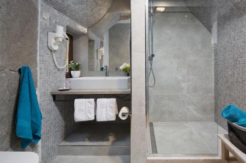a bathroom with a shower and a sink at Rialto Residence in Labin