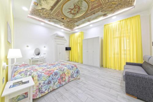 a bedroom with a bed and a couch at B&B Rest a Napoli in Naples