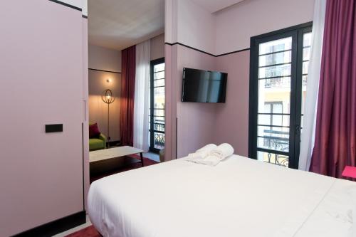 Łóżko lub łóżka w pokoju w obiekcie Amor de Dios 17 Boutique Apartments