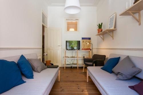 a living room with two couches and a tv at Caraujo Apartments in Lisbon