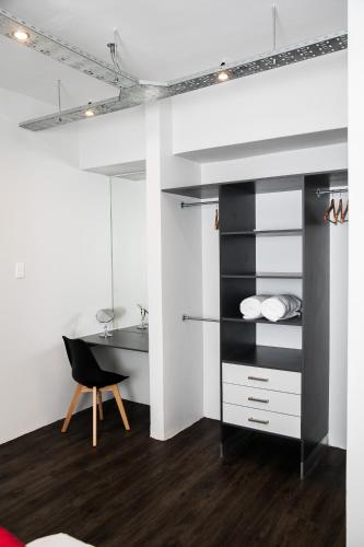 a bedroom with a desk and a chair at Zeederberg Corner in Paarl
