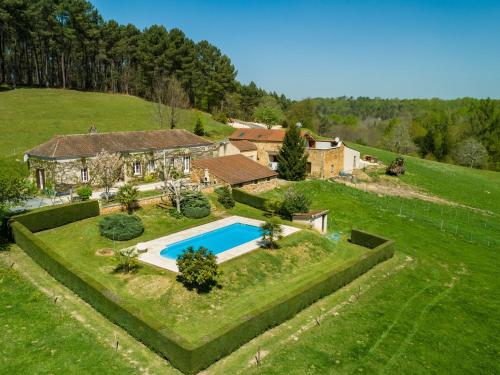 an aerial view of a house with a swimming pool at Beautiful holiday home with nature views in Villefranche-du-Périgord