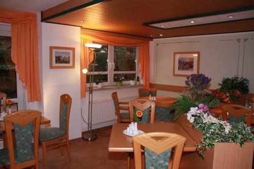 a dining room with a table and chairs at Hotel-Garni Elbgarten Bad Schandau in Bad Schandau