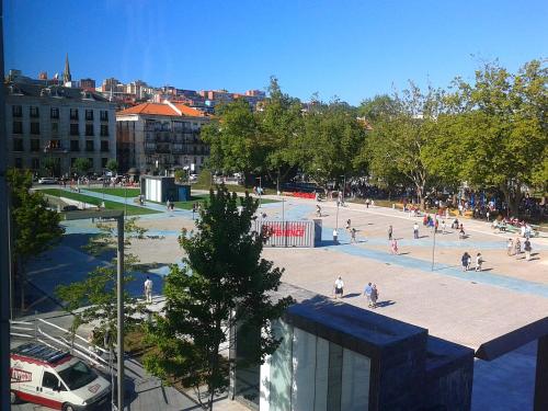a group of people walking around a plaza in a city at Hotel Bahía in Santander