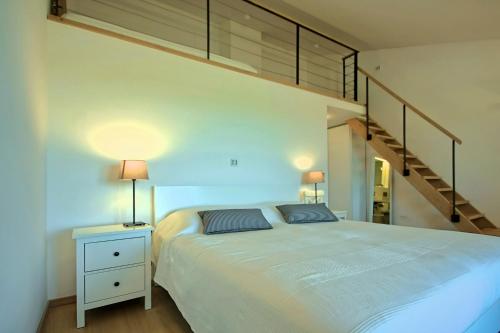 a bedroom with a large bed and a staircase at Villa Bianca in Svetvinčenat