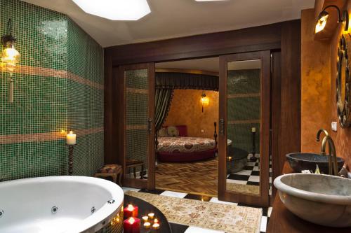 a bath room with a tub and a mirror at Sokullu Pasa Hotel - Special Class in Istanbul