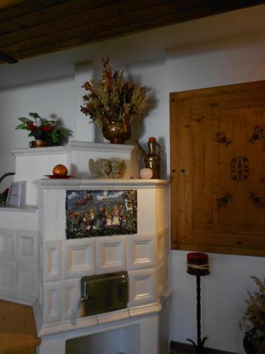 a room with a white wall with a wooden door at Pension Thorerhof in Haus im Ennstal