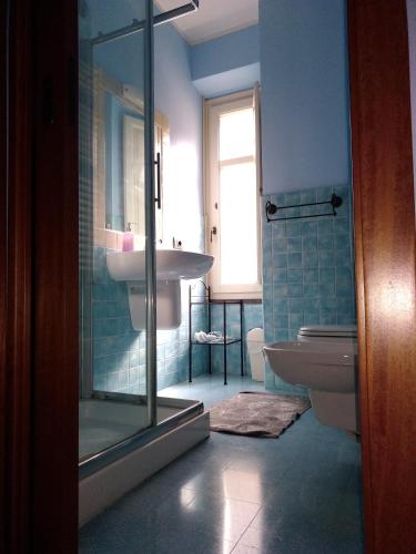 a bathroom with a shower and a sink and a toilet at La Corte di Lucina in Terralba