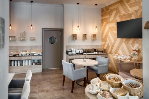 a room with a table and chairs and a kitchen at Hotel Florenc in Prague