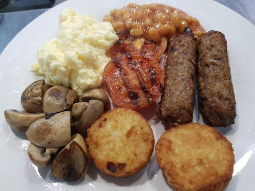 a plate of breakfast food with eggs potatoes and mushrooms at Angel Guesthouse in Tiverton