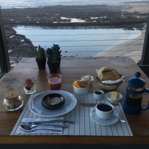 a table with a plate of food on top of a table at Hotel Apacheta in Arica