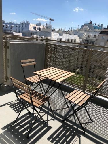 a table and two chairs sitting on a balcony at Best Place Apartments Vienna in Vienna