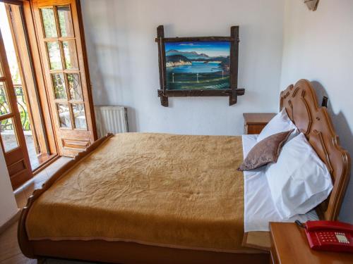a bedroom with a bed and a mirror on the wall at Arhontiko in Psarádes