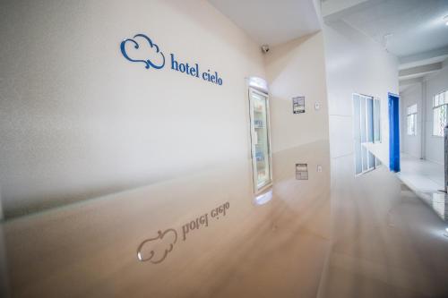 a hallway with a wall with two cloud drawings on it at Hotel Cielo in Porto Velho