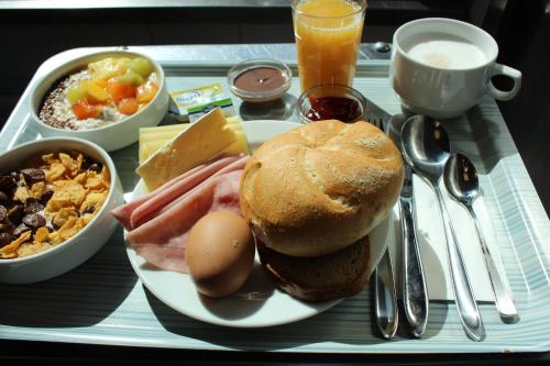 a tray of food with a sandwich and other breakfast foods at Jugendgästehaus Brigittenau &Brigittenau Youth Palace in Vienna
