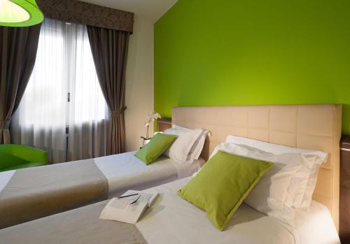 En eller flere senge i et værelse på Hotel Milano Palmanova