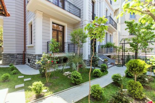 an apartment building with a garden in front of it at Villa Garden in Tbilisi City