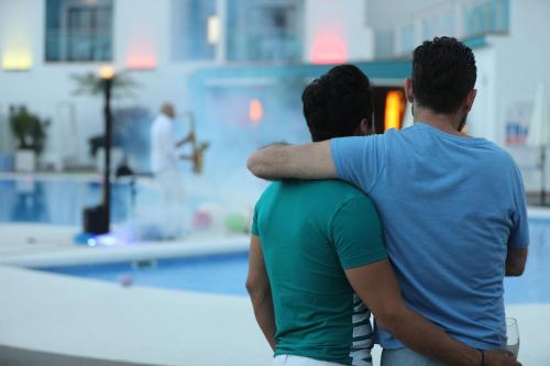 a group of three men hugging each other at Hotel Ritual Torremolinos- Adults Only in Torremolinos