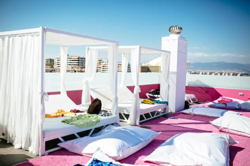 a room with four beds on a roof at Hotel Ritual Torremolinos- Adults Only in Torremolinos