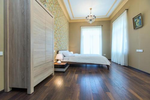 a bedroom with a bed and a large sliding door at Villa Garden in Tbilisi City