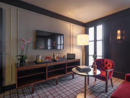 巴塞罗那Wittmore Hotel - Adults Only, Small Luxury Hotels的客厅里有一把红色的椅子和一张桌子