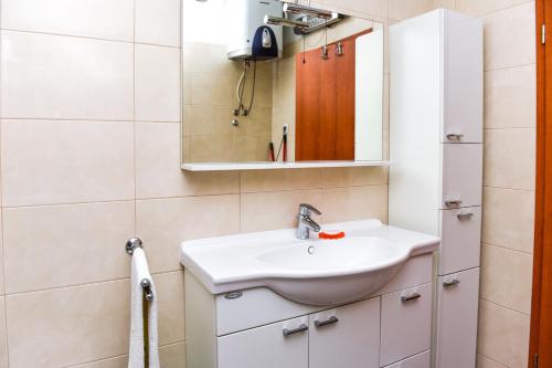 a bathroom with a sink and a mirror at Apartments Purkovic in Vodice