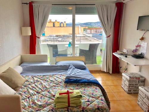 a bedroom with a bed and a large window at Les Hauts de Lérins - Cannes Marina in Mandelieu-La Napoule