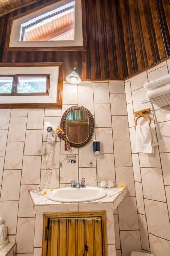 a bathroom with a sink and a mirror at Sueños del Bosque Lodge in San Gerardo de Dota