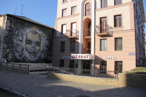 a brick building with a clock on the side of it at Hotel Karat in Kazan