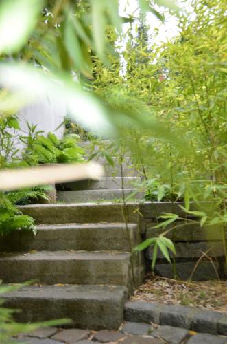 a set of stone stairs in a garden at Ringhotel Alpenhof - Patchworkhotel in Augsburg