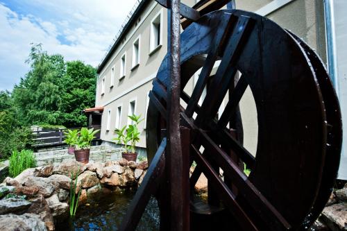 a water wheel in front of a building at Rancho Ślężański Młyn in Szczepanów