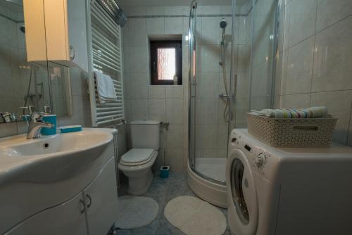 a bathroom with a sink and a toilet and a shower at Villa Sunset in Jadranovo