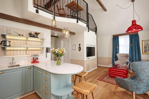 a kitchen with blue cabinets and a table and chairs at Reykjavik Marina - Berjaya Iceland Hotels in Reykjavík