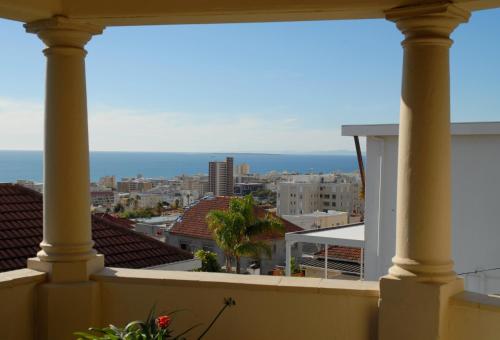 a view of the ocean from the balcony of a building at Maartens Guesthouse in Cape Town