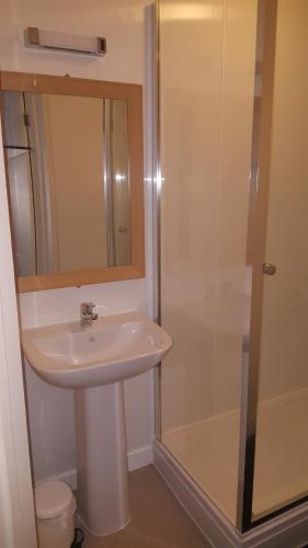 a bathroom with a sink and a shower at Angel Guesthouse in Tiverton