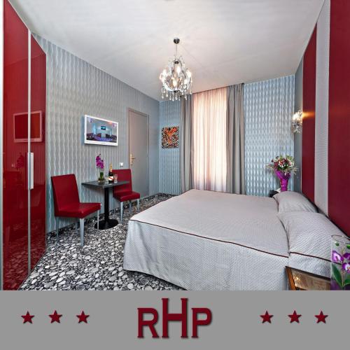 a bedroom with a bed and a table and chairs at Hotel Relais Dei Papi in Rome