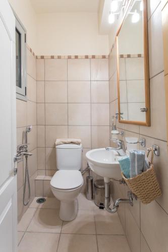 a bathroom with a toilet and a sink at Comfortable house with amazing view in Anavyssos