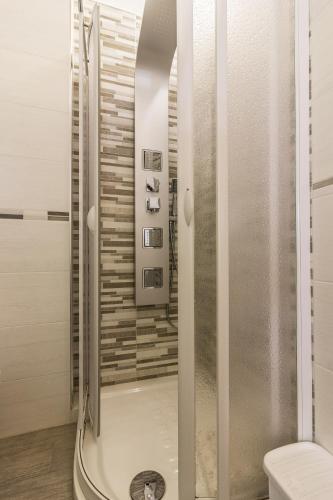 a shower with a glass door in a bathroom at SANT'ANDREA APARTMENT in Molfetta