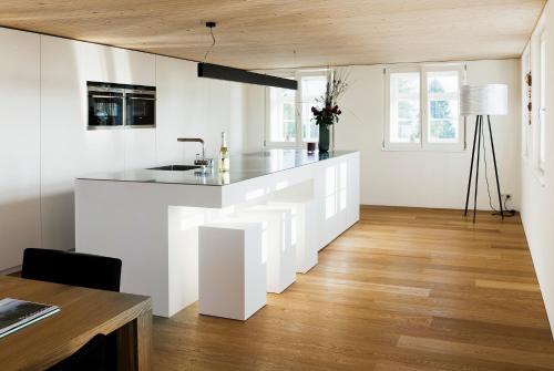 a kitchen with white walls and a counter top at Mesmerhaus in Bildstein