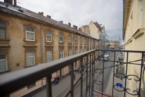 a view of a city street from a balcony at Aparthotel NA DOBU in Lviv